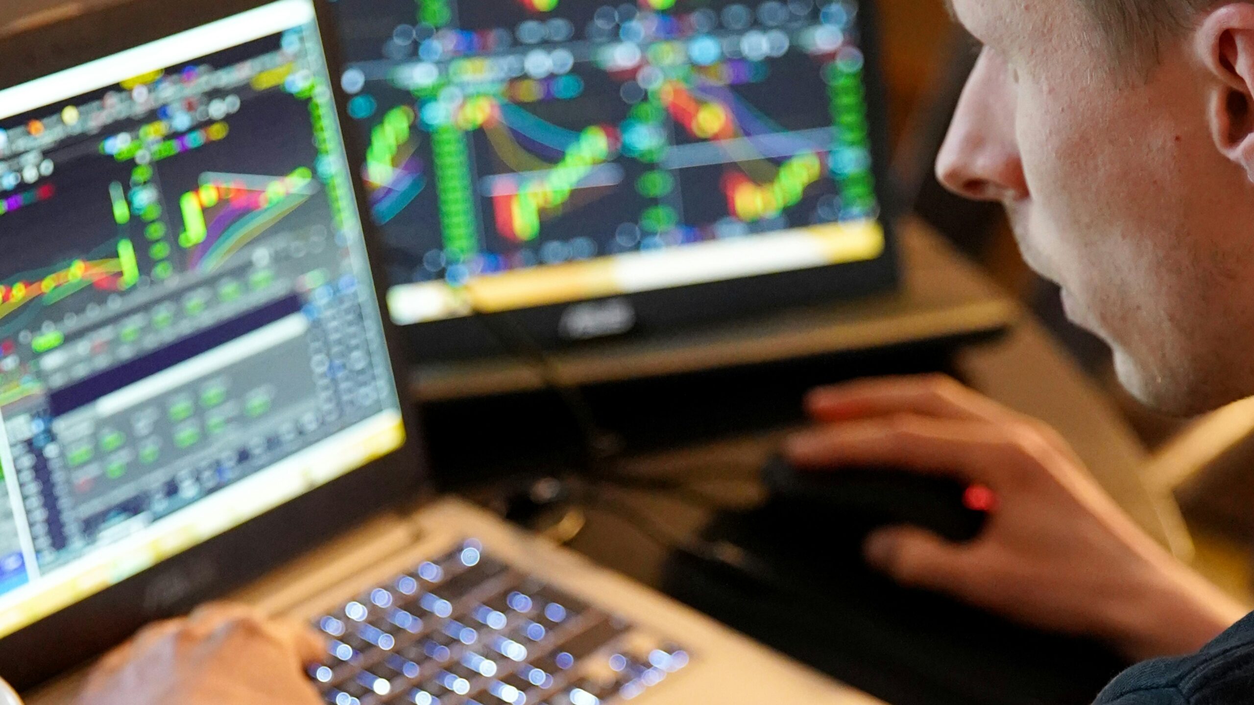 Man sitting in front of 2 monitors